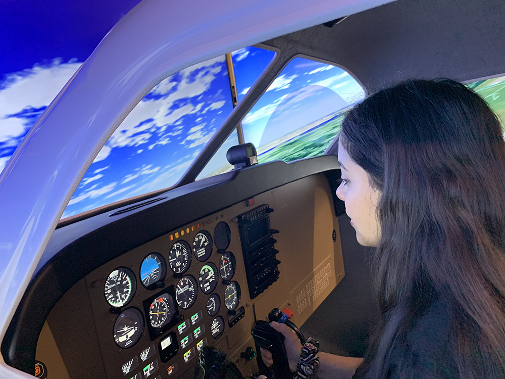 Girl Piloting Flight Simulator
