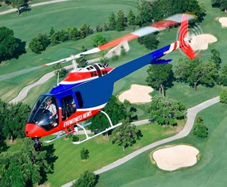 KCPS helicopter in the air over a golf course.