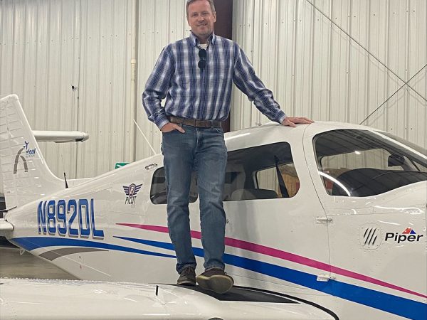 Jim Moseley posing with a plane.