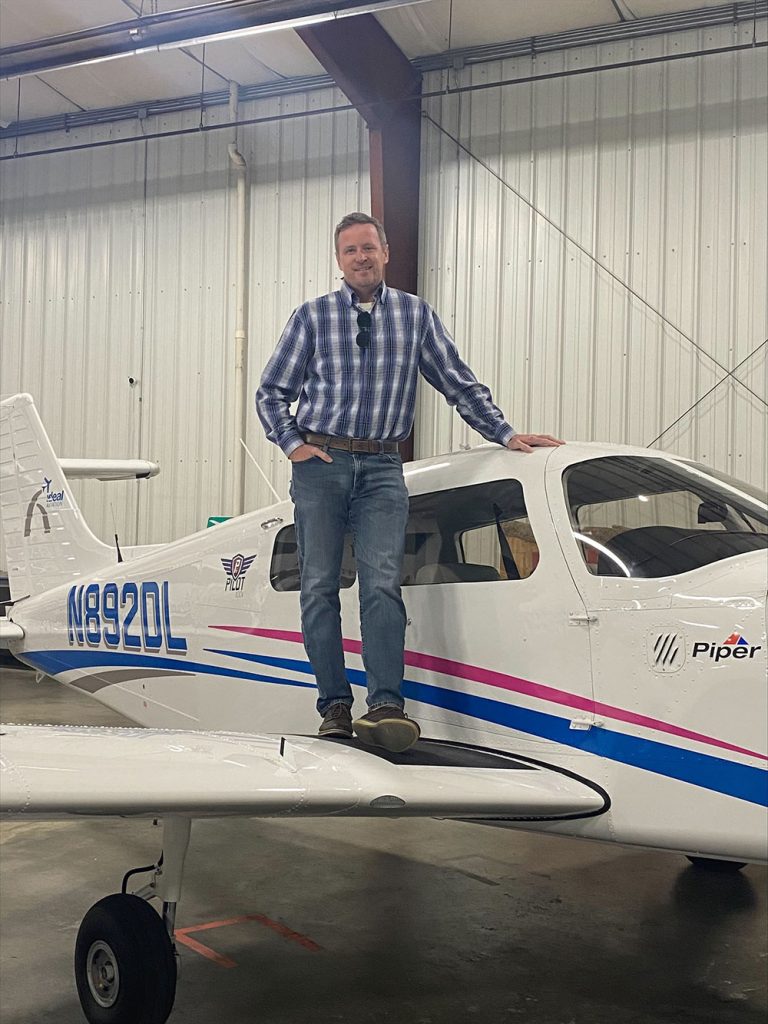 Jim Moseley posing with a plane.