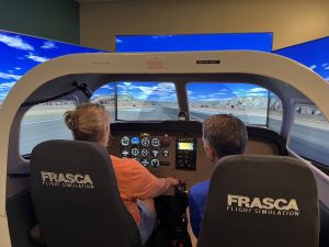 Participants in Aviation Day for Educators in a flight simulator