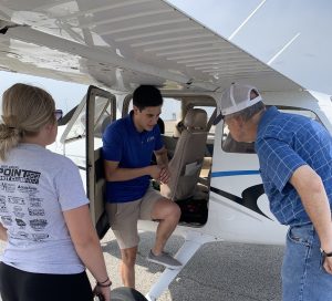 Pilot Santamaria chats with participants in Aviation Day for Educators in front of a plane