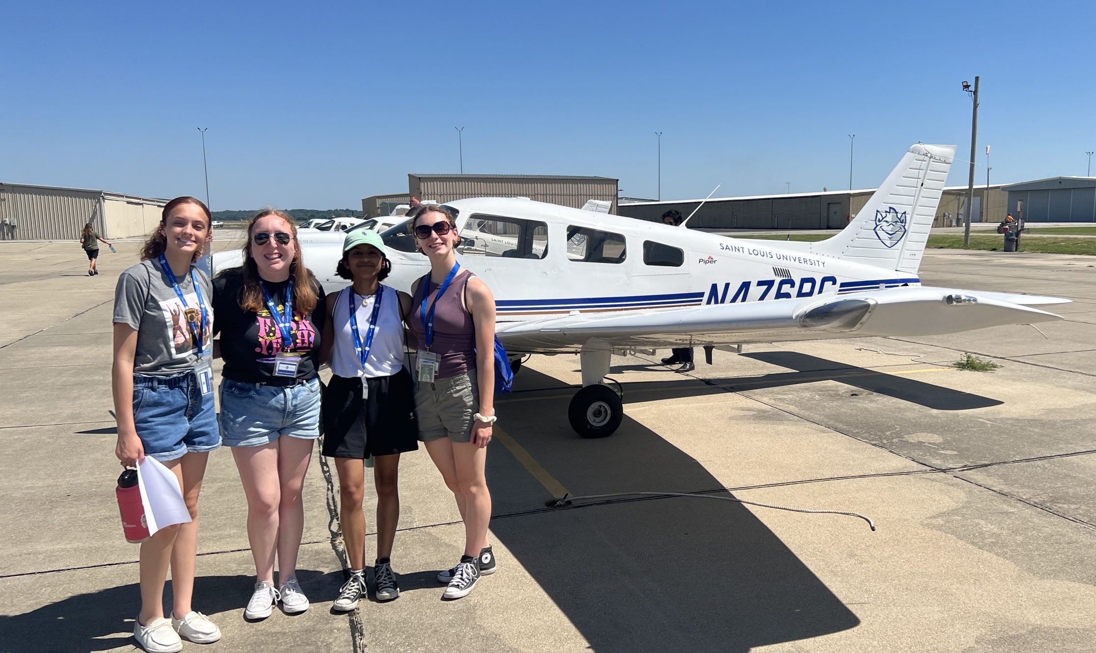 Group of students at Aviation Summer Academy in front of a plane