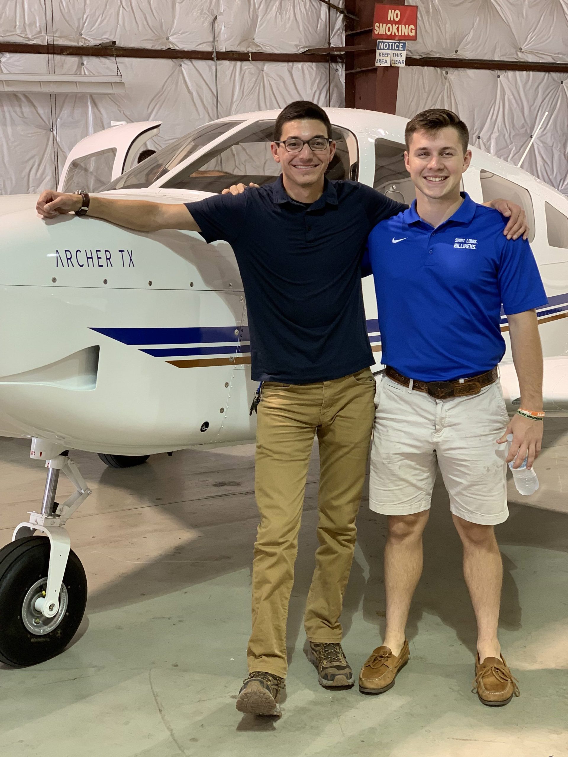 Photo of Luke Pereles and Tyler Johnson in front of a plane