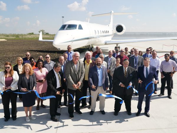 Photo of officials cutting the ribbon at the completion of the new Ground Engine Run-Up and Compass Calibration Pad