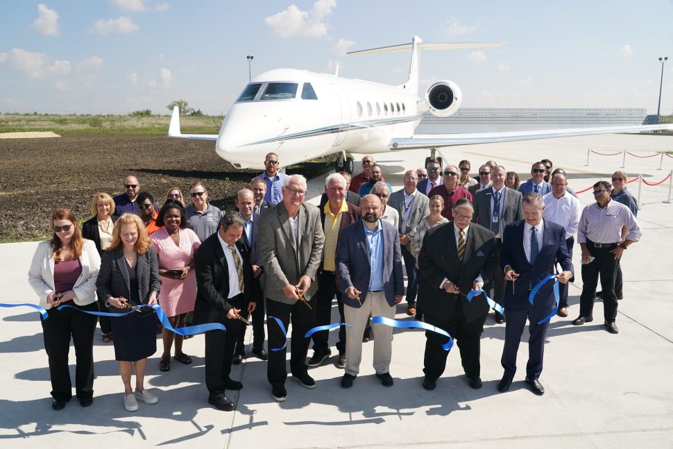 Photo of officials cutting the ribbon at the completion of the new Ground Engine Run-Up and Compass Calibration Pad