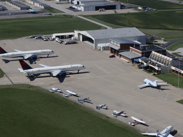 Photo of several planes of different sizes parked outside the terminal at St. Louis Downtown Airport