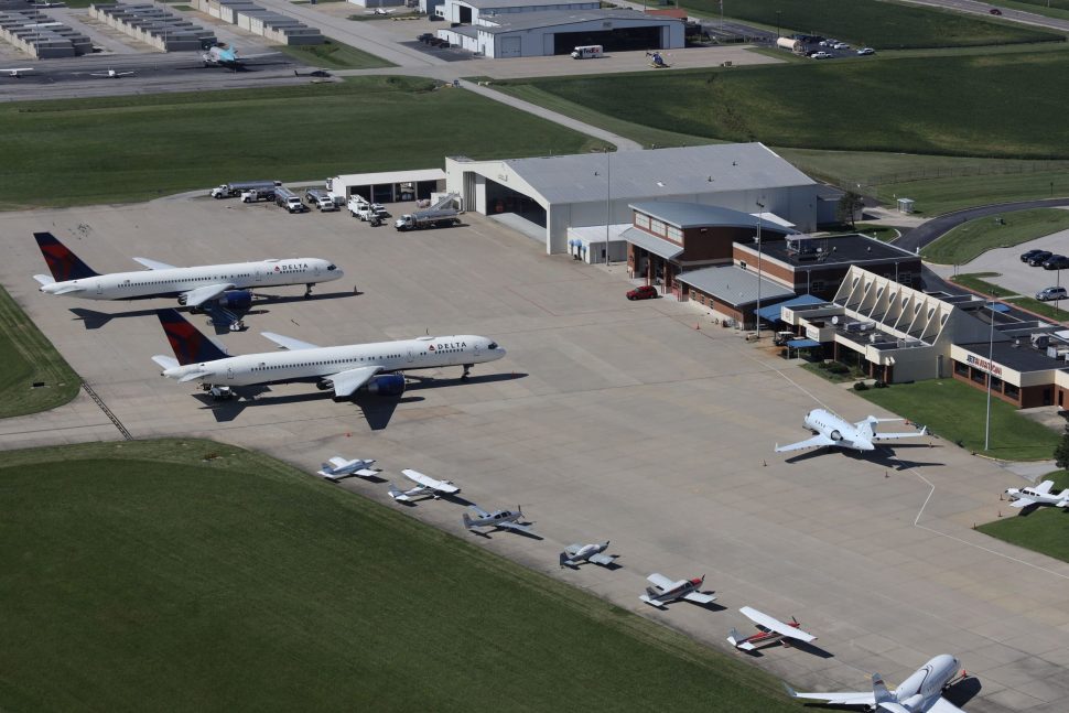 Photo of several planes of different sizes parked outside the terminal at St. Louis Downtown Airport