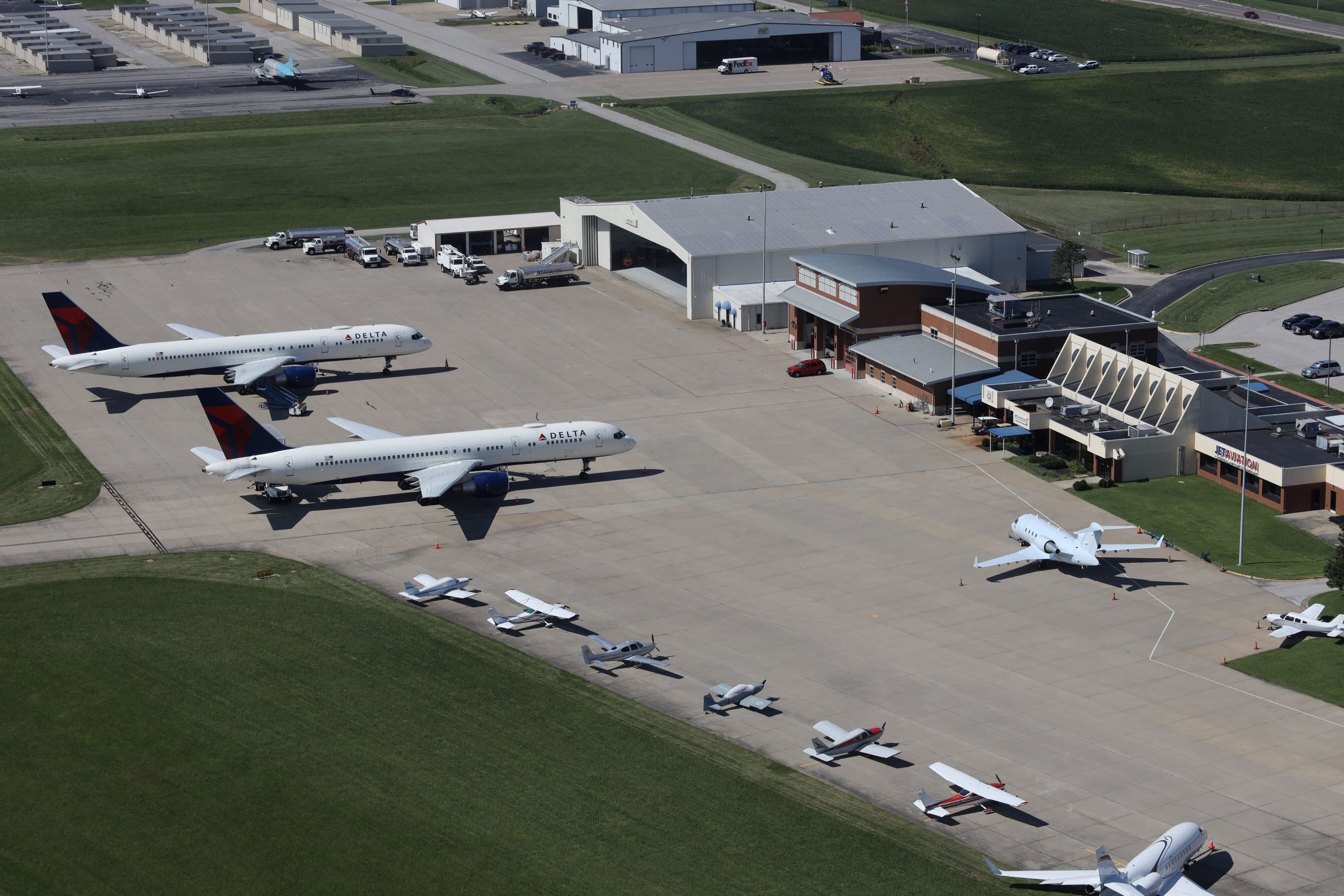 Photo of several planes of different sizes parked outside the terminal at St. Louis Downtown Airport