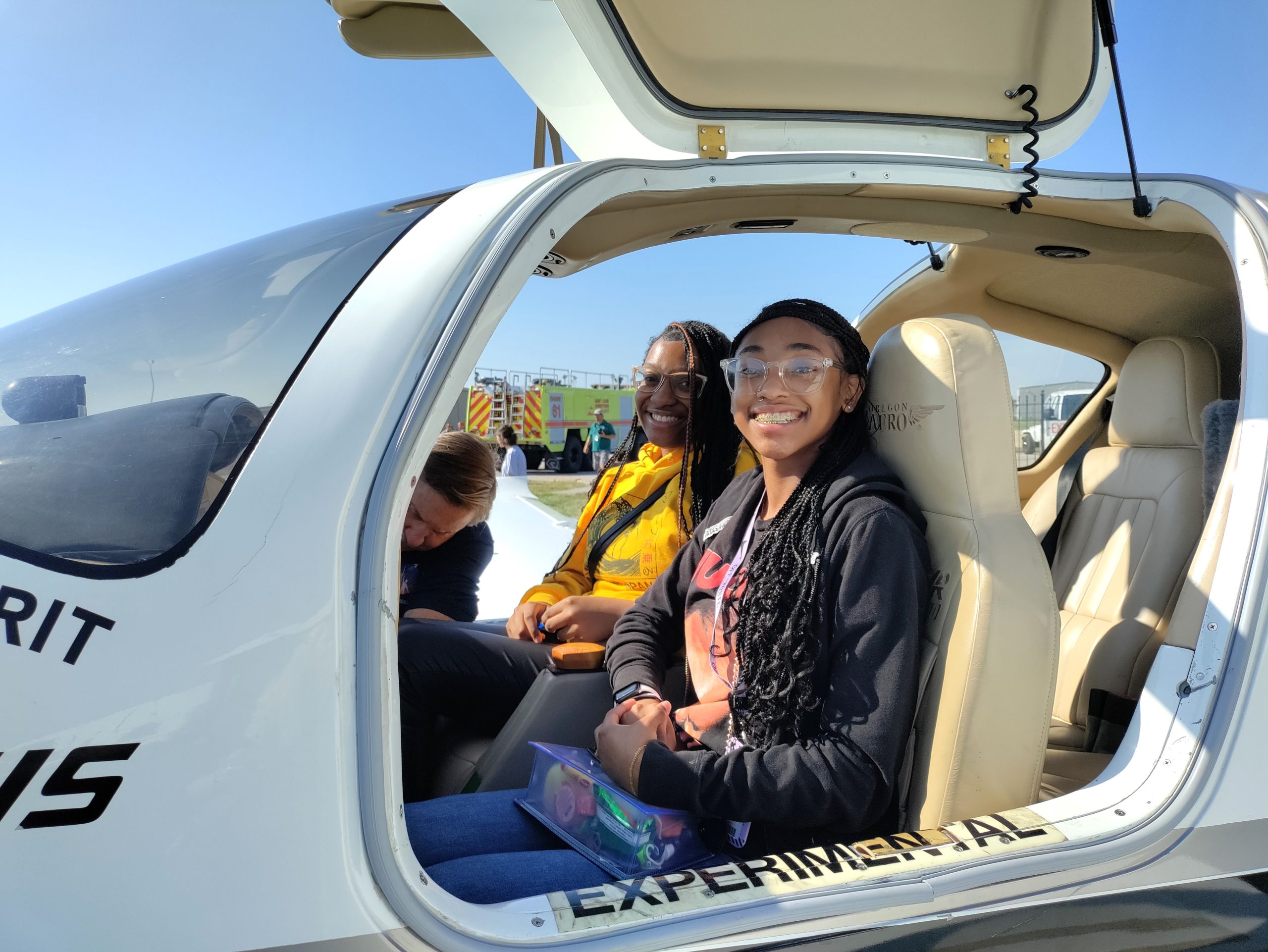 Photo of two 9th grade students in a small plane