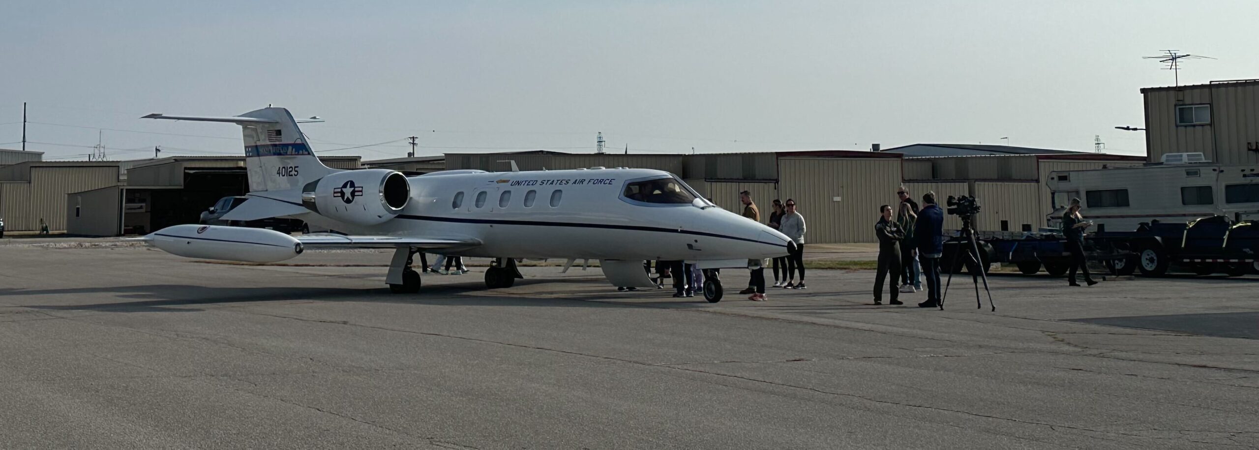 Group of young women next to a commuter jet