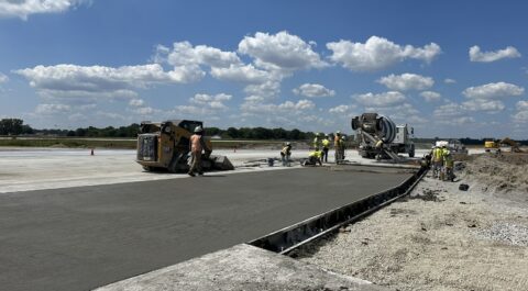 Crews lay down concrete for new airport runway